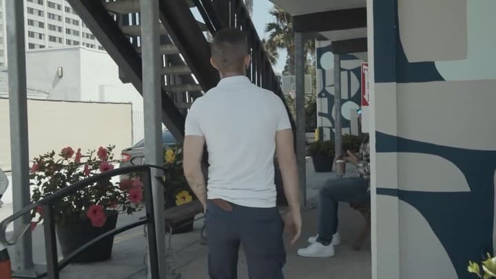 Client walking calmly along the exterior path of the facility.