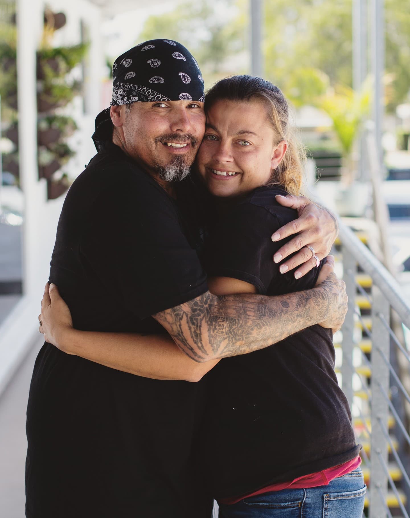 Smiling couple hugging each other during an outdoor break.